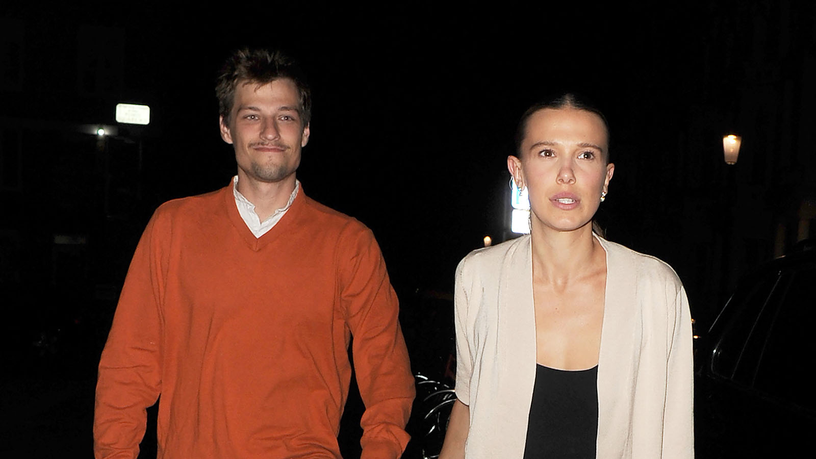 Millie Bobby Brown wearing a cardigan, polka dot capris, and ballet pumps