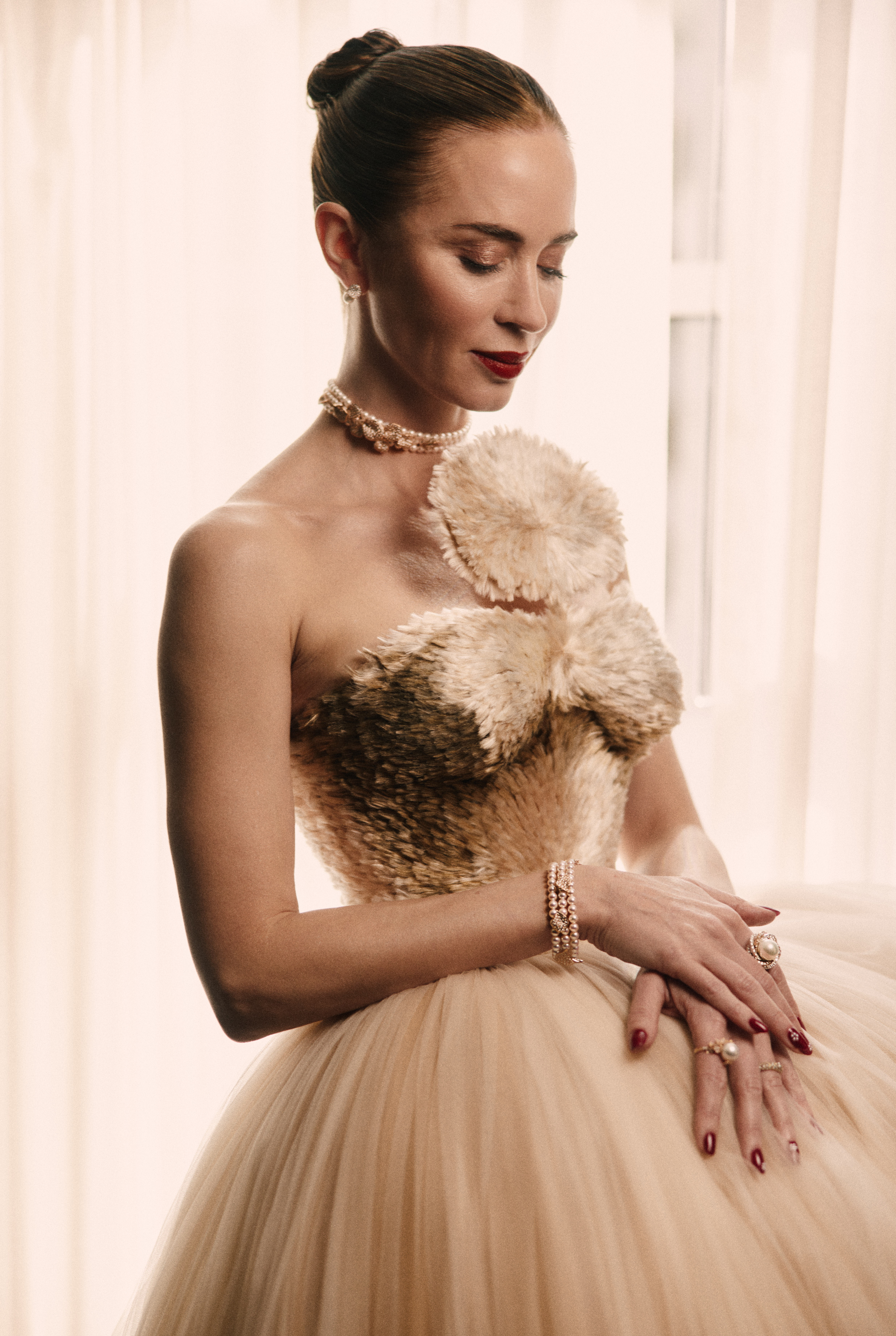 Emily Blunt wearing a schiaparelli dress and mikimoto pearls