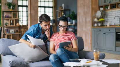 A young couple looks at high-yield savings account info.