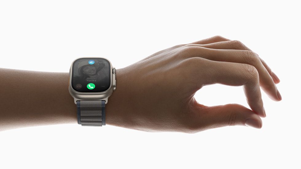 Apple Watch Ultra 2 on a hand that has the index finger and thumb pressed together.