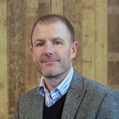 A man in a tweed suit jacket
