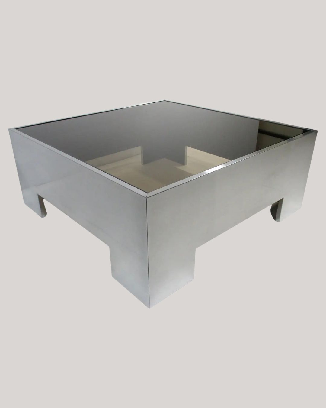Milo Baughman Stainless Steel Glass Coffee Table for DIA against pale beige background.