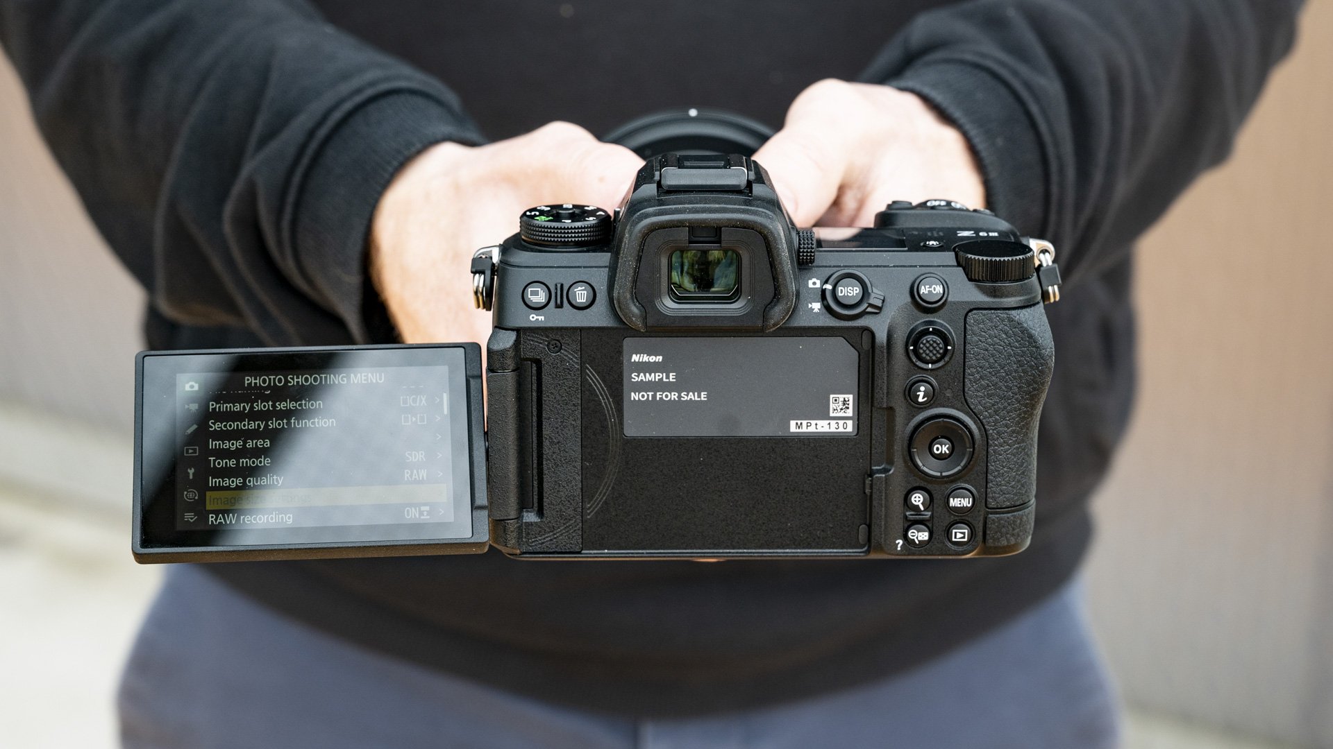 Nikon Z6 III camera in the hand, rear-on with flip-out touchscreen