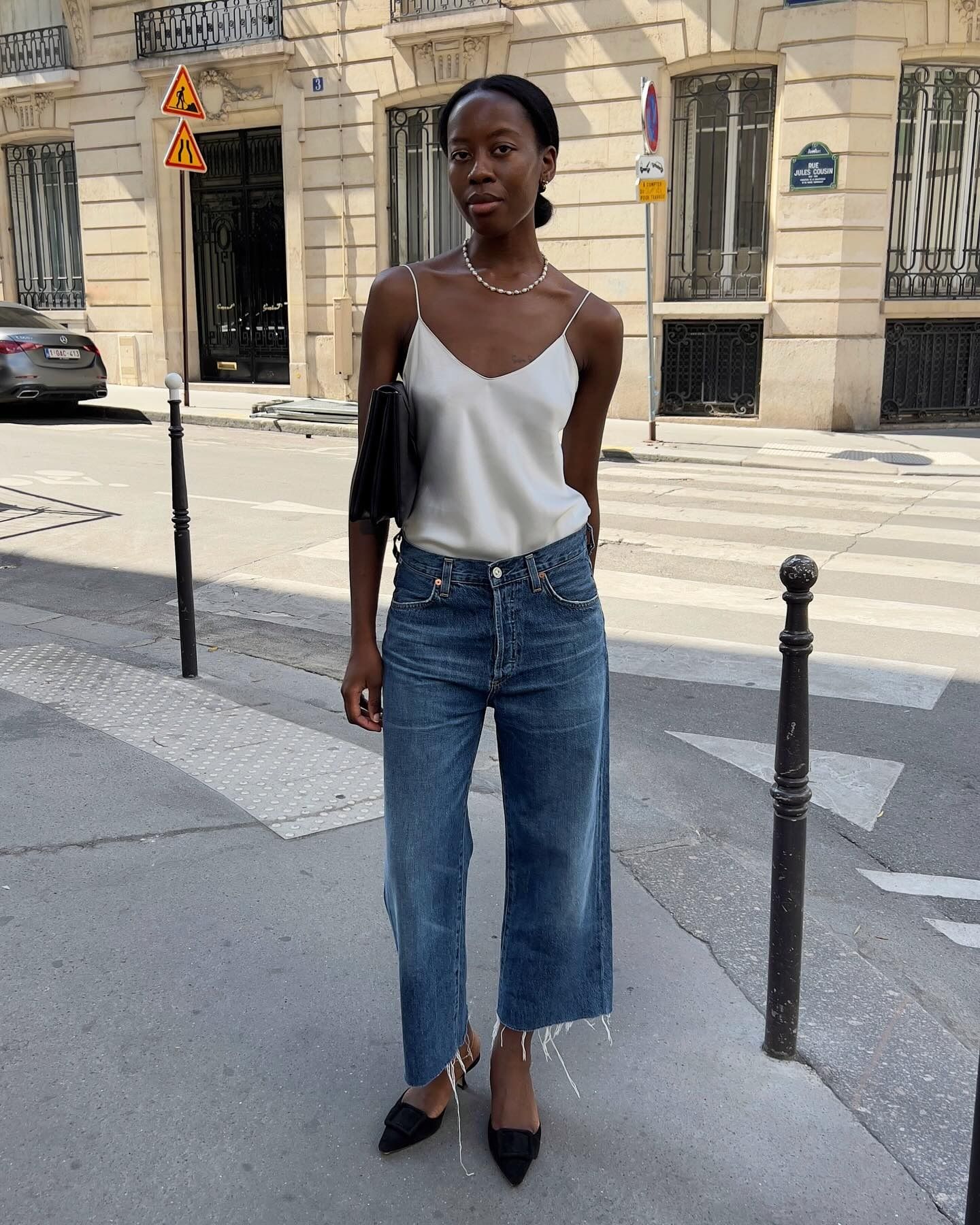 Woman in relaxed crop jeans and silk camisole