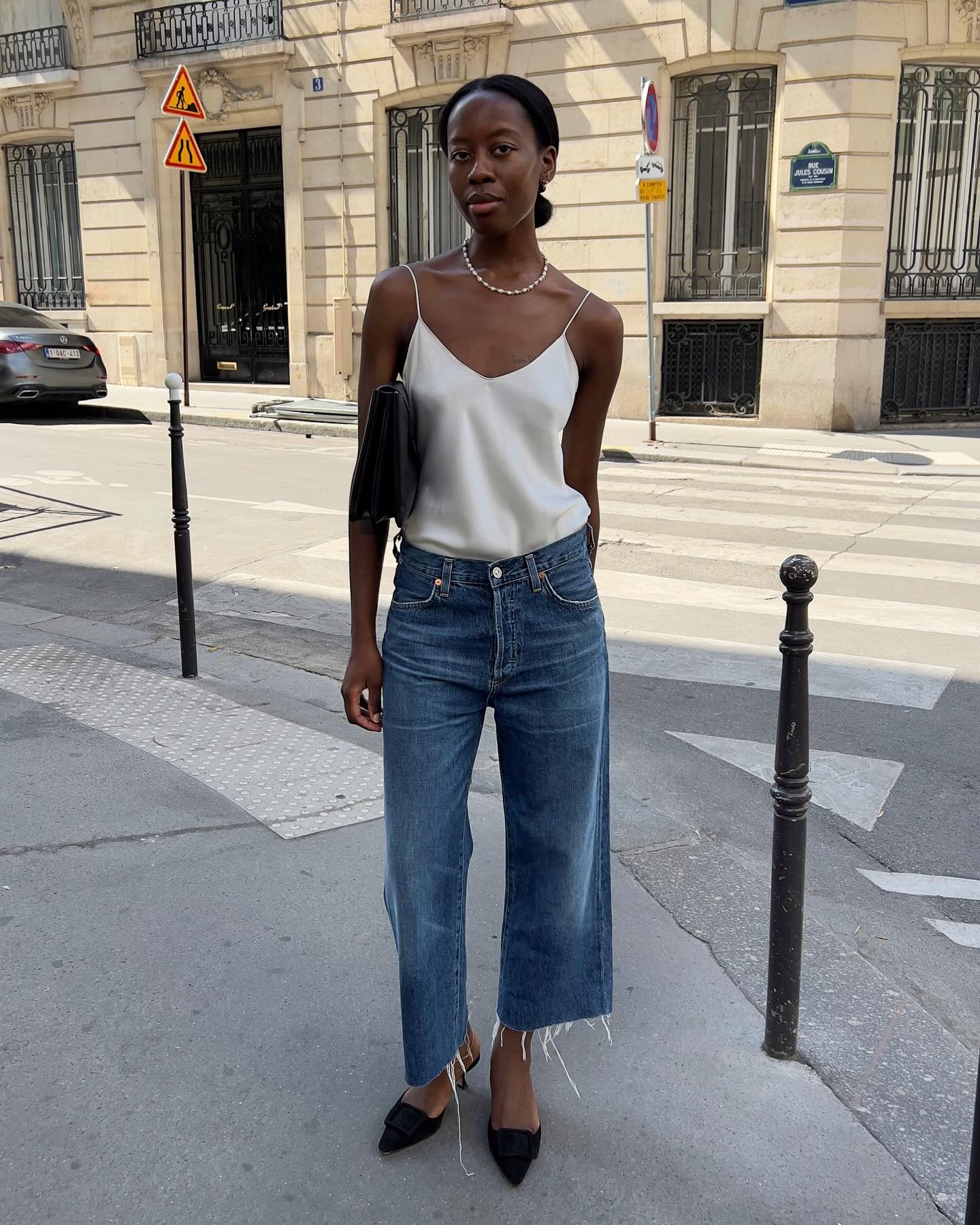 Woman in relaxed crop jeans and silk camisole