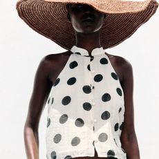 Woman wears straw hat and polka dot top