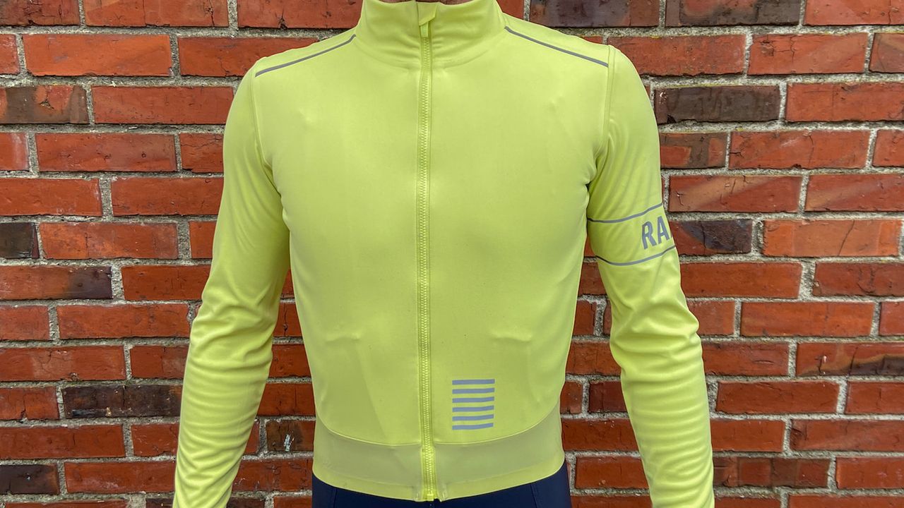 Image shows a rider wearing Rapha Men&#039;s Pro Team Long Sleeve Gore-Tex Infinium Jersey