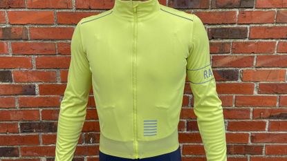 Image shows a rider wearing Rapha Men's Pro Team Long Sleeve Gore-Tex Infinium Jersey
