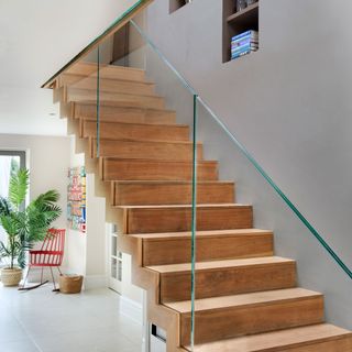 wooden staircase with glass balustrade