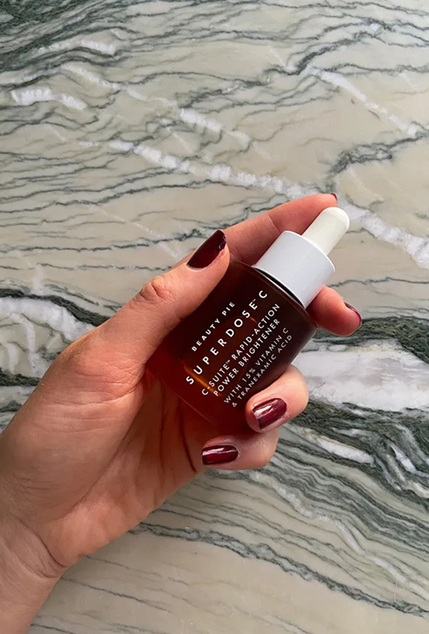 Beauty Pie vitamin C serum bottle on marble table