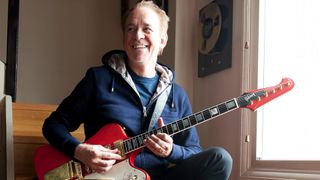 Phil Manzanera poses with a Gibson Firebird in his home studio