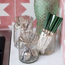 Glass jars storing silver cutlery