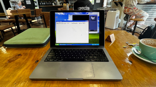 Windows XP on an M1 MacBook Pro in a coffee house