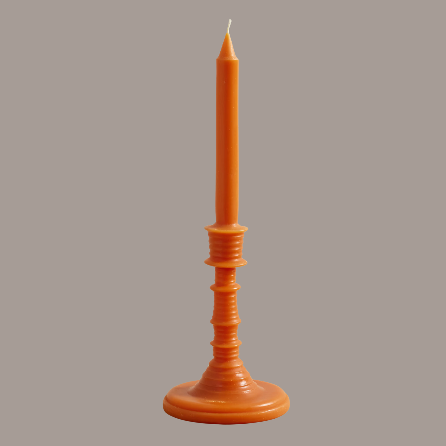 An orange taper candle