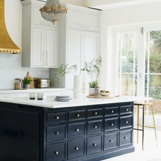 A large kitchen with a kitchen island in the middle and a chandelier