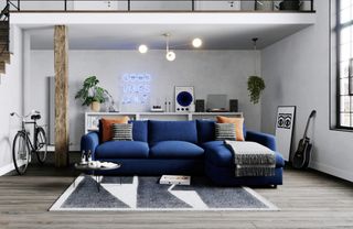 A chaise sofa with blue velvet upholstery in a modern apartment