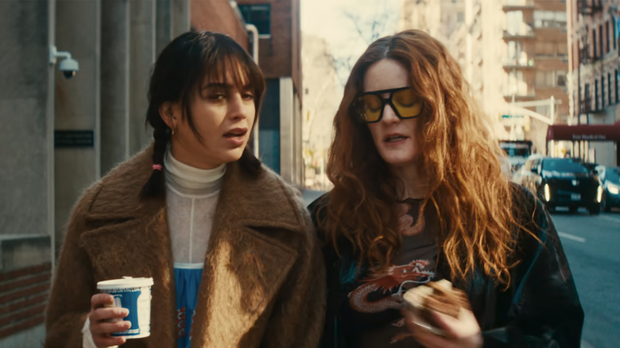 Two women walking on a city street in Your Monster.