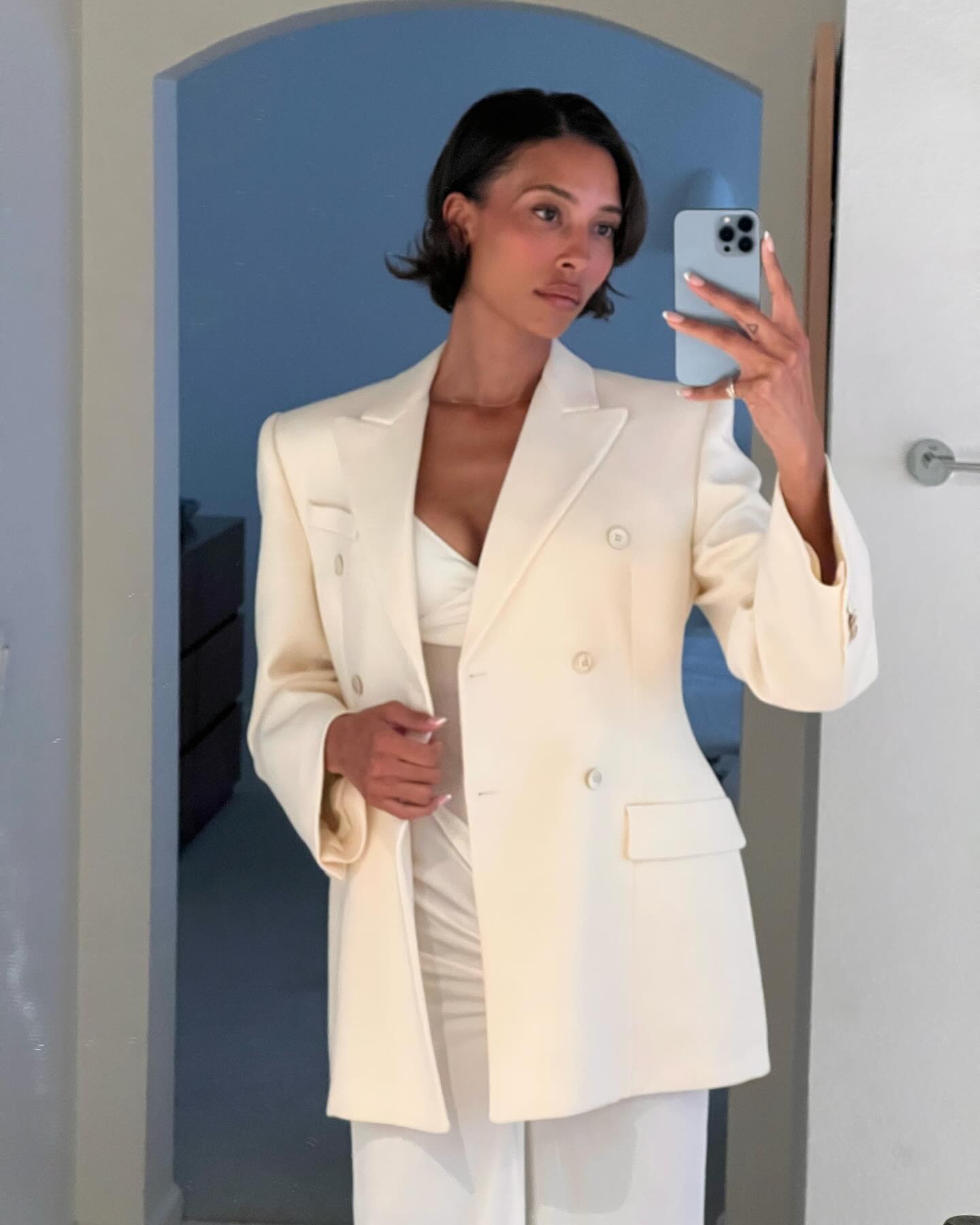 Bob hairstyle with a woman taking a picture in white blazer