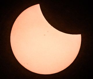 As the moon began to eclipse the sun on Aug. 21, 2017, a few sunspots were visible on the solar surface.