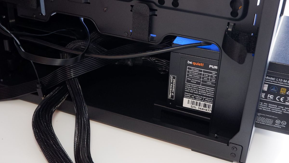 Arctic's Xtender PC case on a white desk with various parts being installed to build a functional gaming PC.