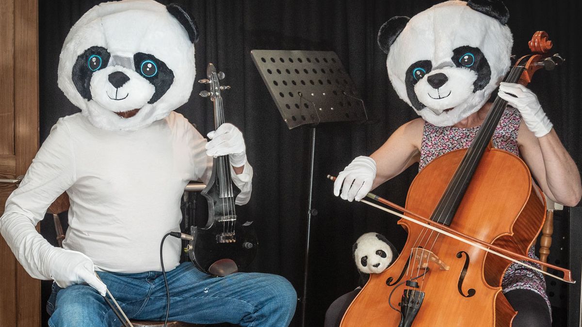 Two people in panda suits playing instruments