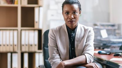 A woman sitting at a desk in an office.