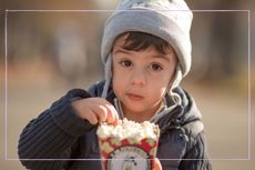 toddler eating popcorn stock image