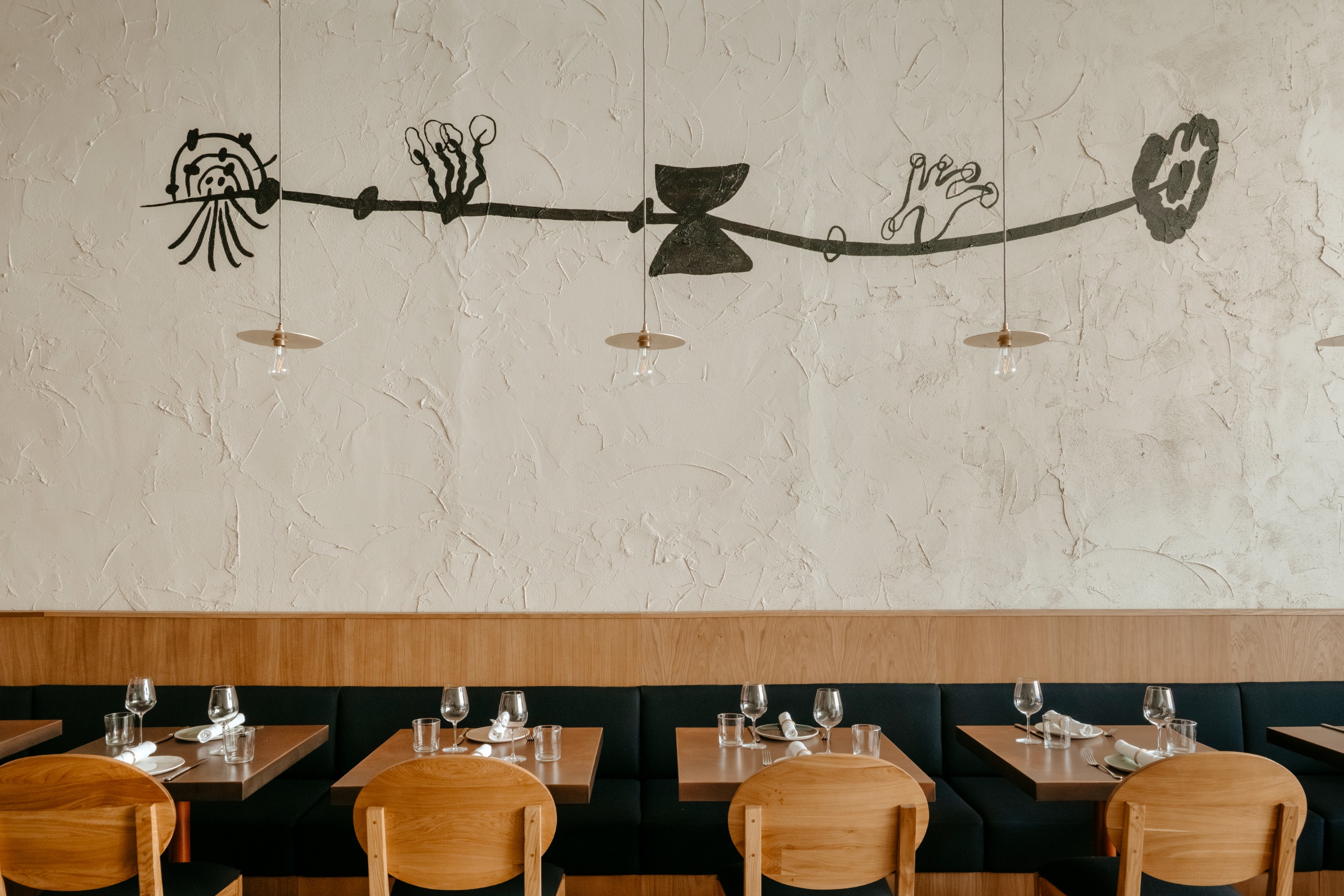 Painted motifs on textured wall inside Ottolenghi Edinburgh restaurant