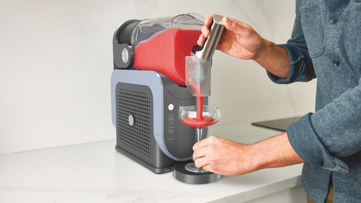 Man pouring drink from Ninja slushie machine