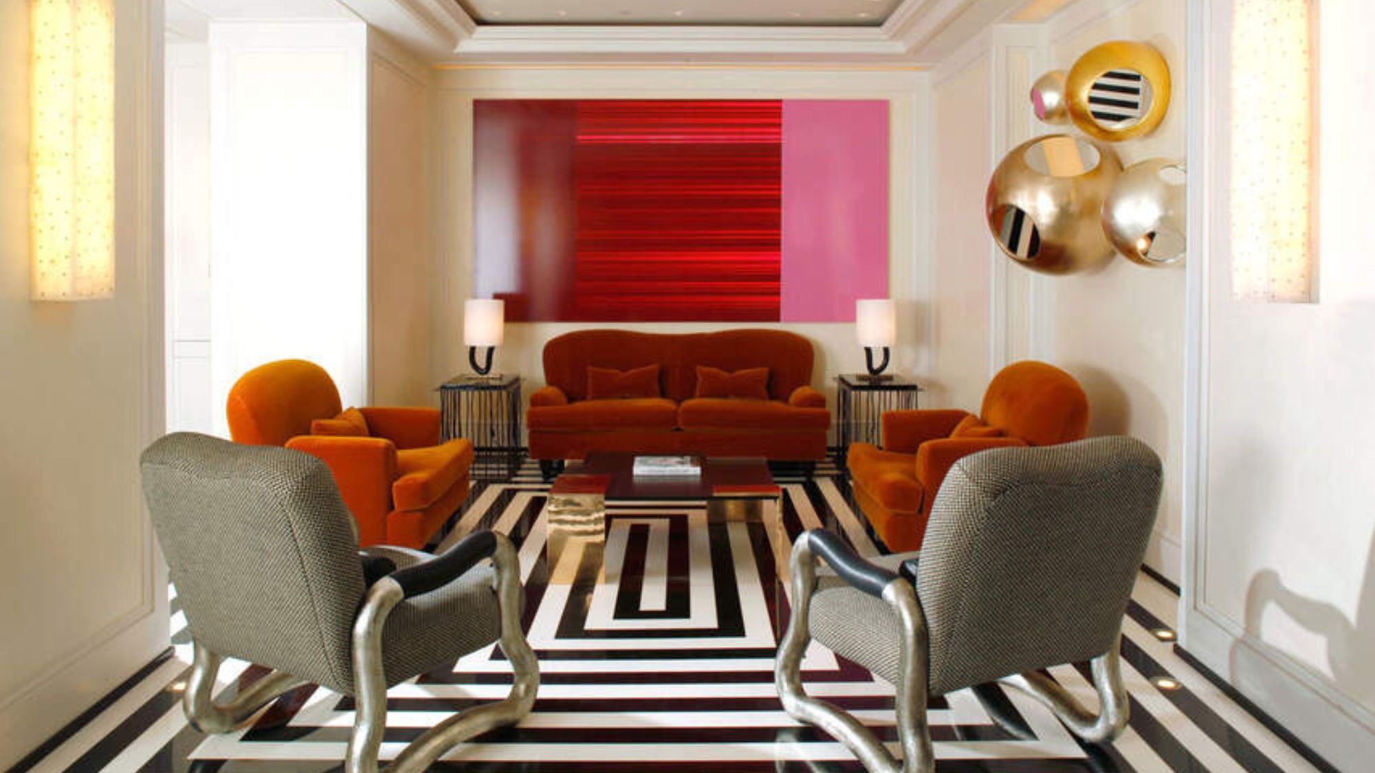 room at the Mark - black and white floors with bright coloured chairs and a red painting