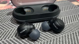 Sony C500 earbuds in black on patterned background