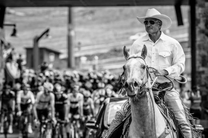 The peloton gets led out of Steamboat Springs by a cowboy.