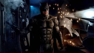 Ben Affleck suited up as Batman near Batmobile in Justice League