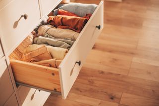 A dresser with folded clothes