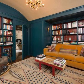 home library with velvet sofa