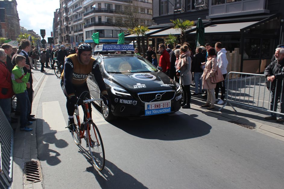 An Eddy Merckx fan tries to tail onto the peloton