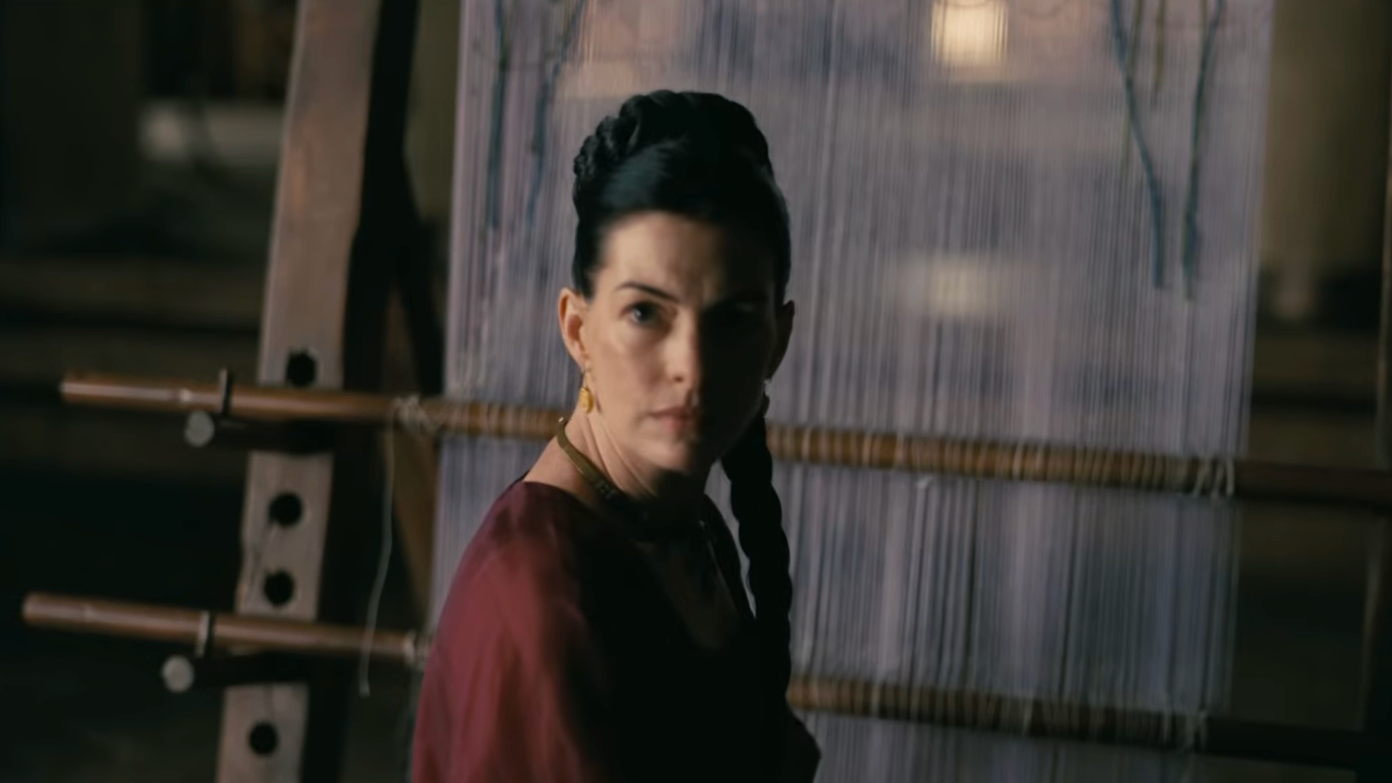 Anne Hathaway turns around with her hair braided in The Odyssey.