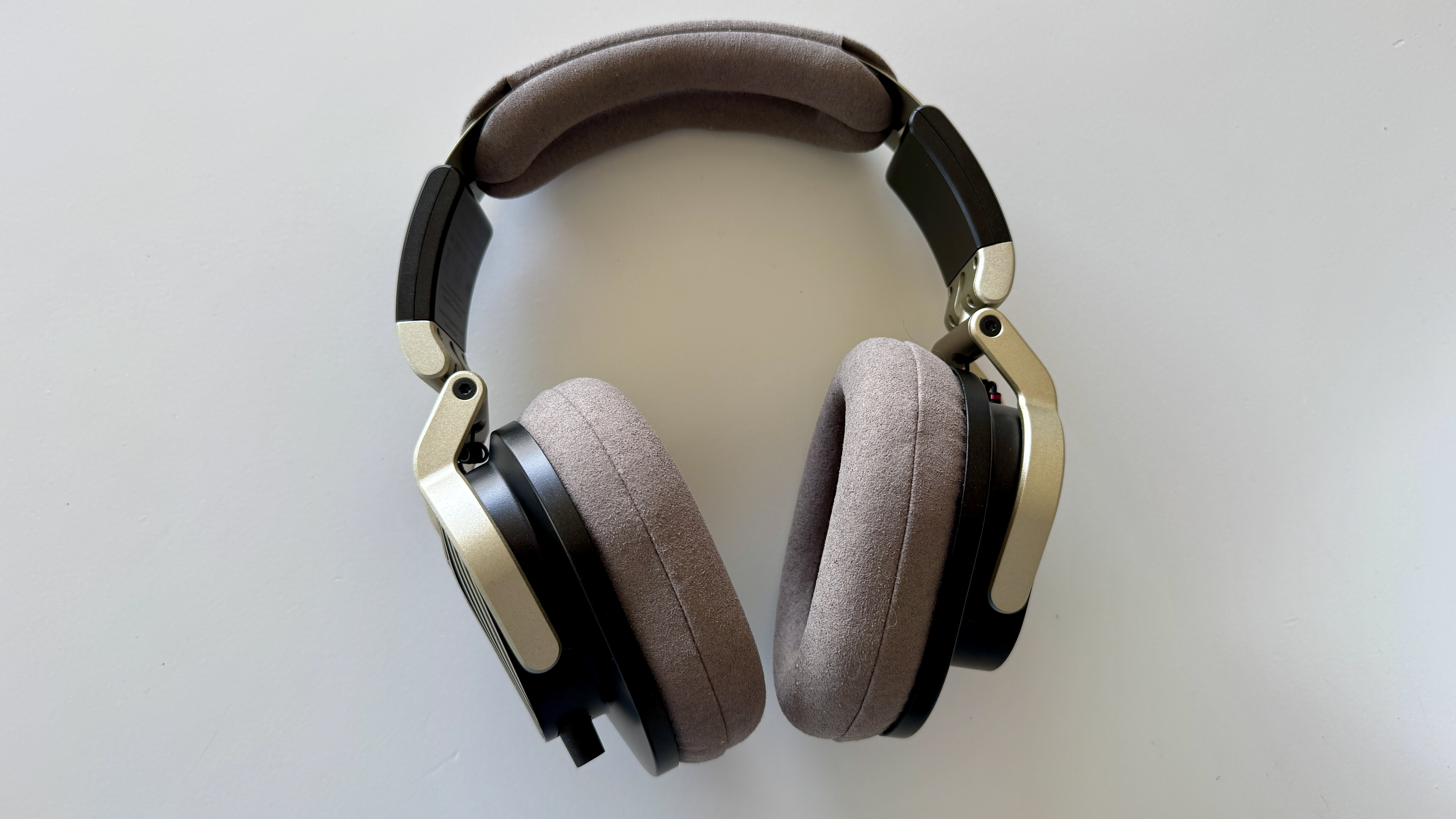 Austrian Audio The Arranger open-backed over-ear headphones on a white surface
