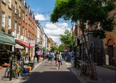 Pedestrians browse shops and restaurants on Exmouth Market in London.