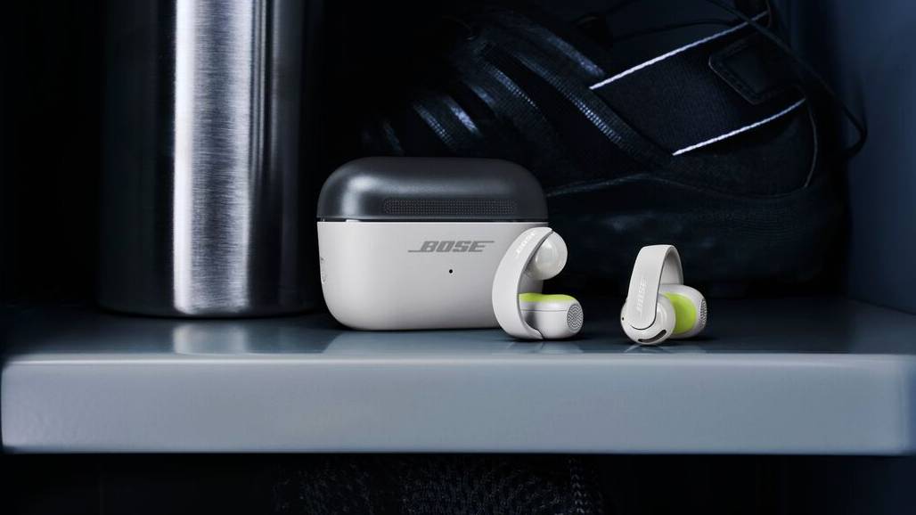 The Bose Sport Open Earbuds next to their case on a shelf.
