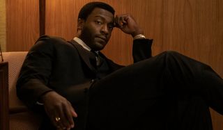 Aldis Hodge sits well dressed in the hotel room in One Night In Miami.
