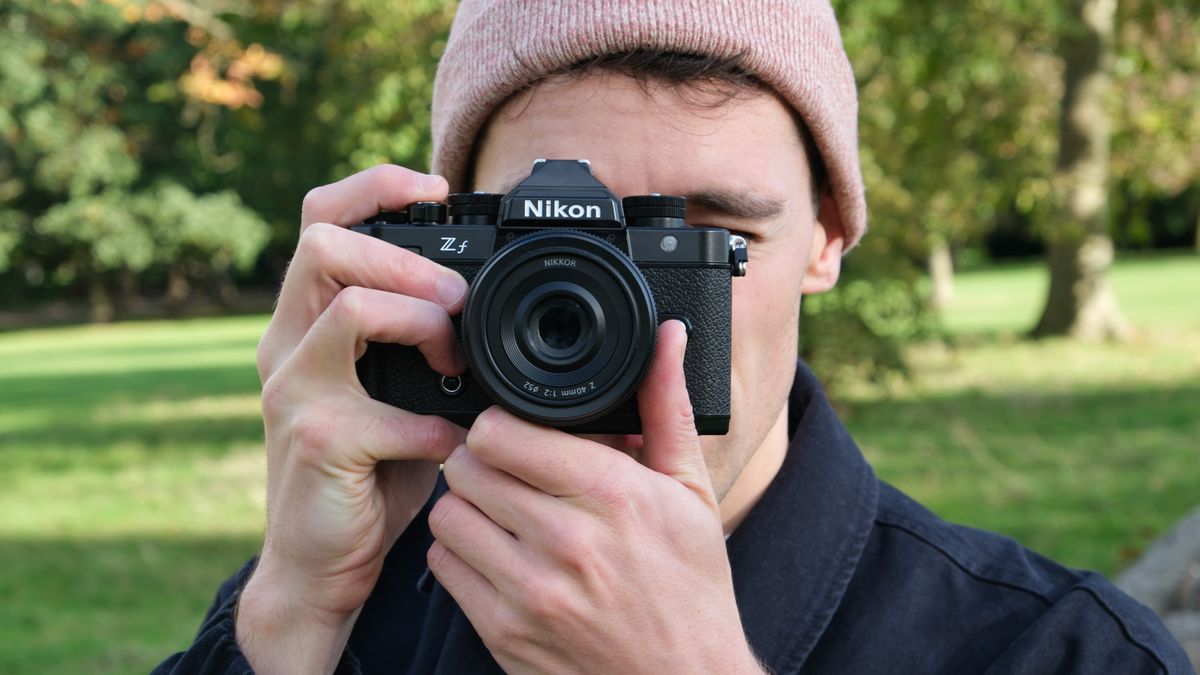 Nikon Zf camera held up to a face