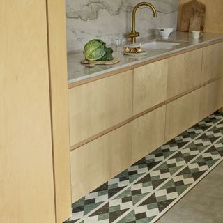 Amtico tiles next to plain flooring in kitchen