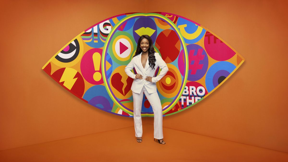 Noky in front of the Big Brother logo.