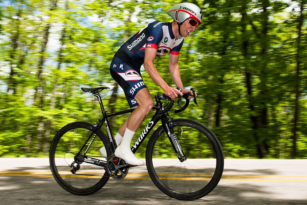 A Canyon Bicycles - Shimano (USA) stomps on his pedals on switchback section of the course.