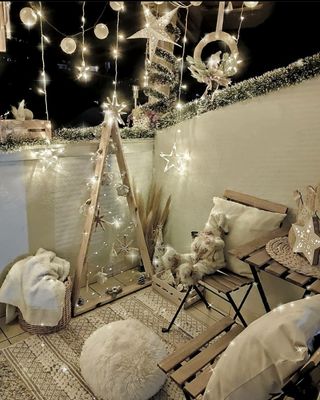 christmas balcony with lights and stars and throws