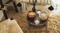 Listing image of a collection of candles on a side table with furniture around it to support easy mistakes when burning scented candles