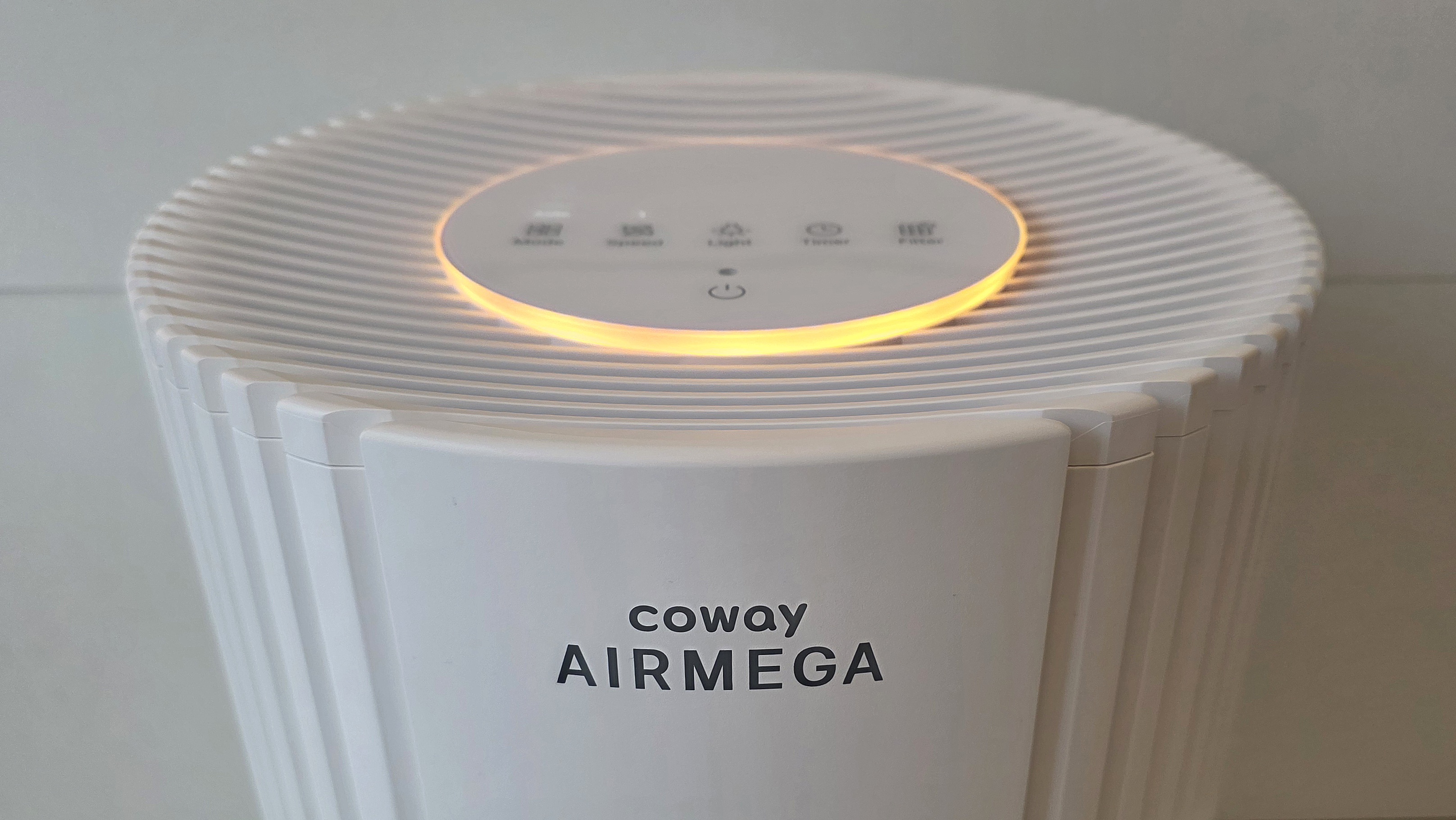 A closeup of the top of the Coway Airmega 350 showing off its multicolor lighting.