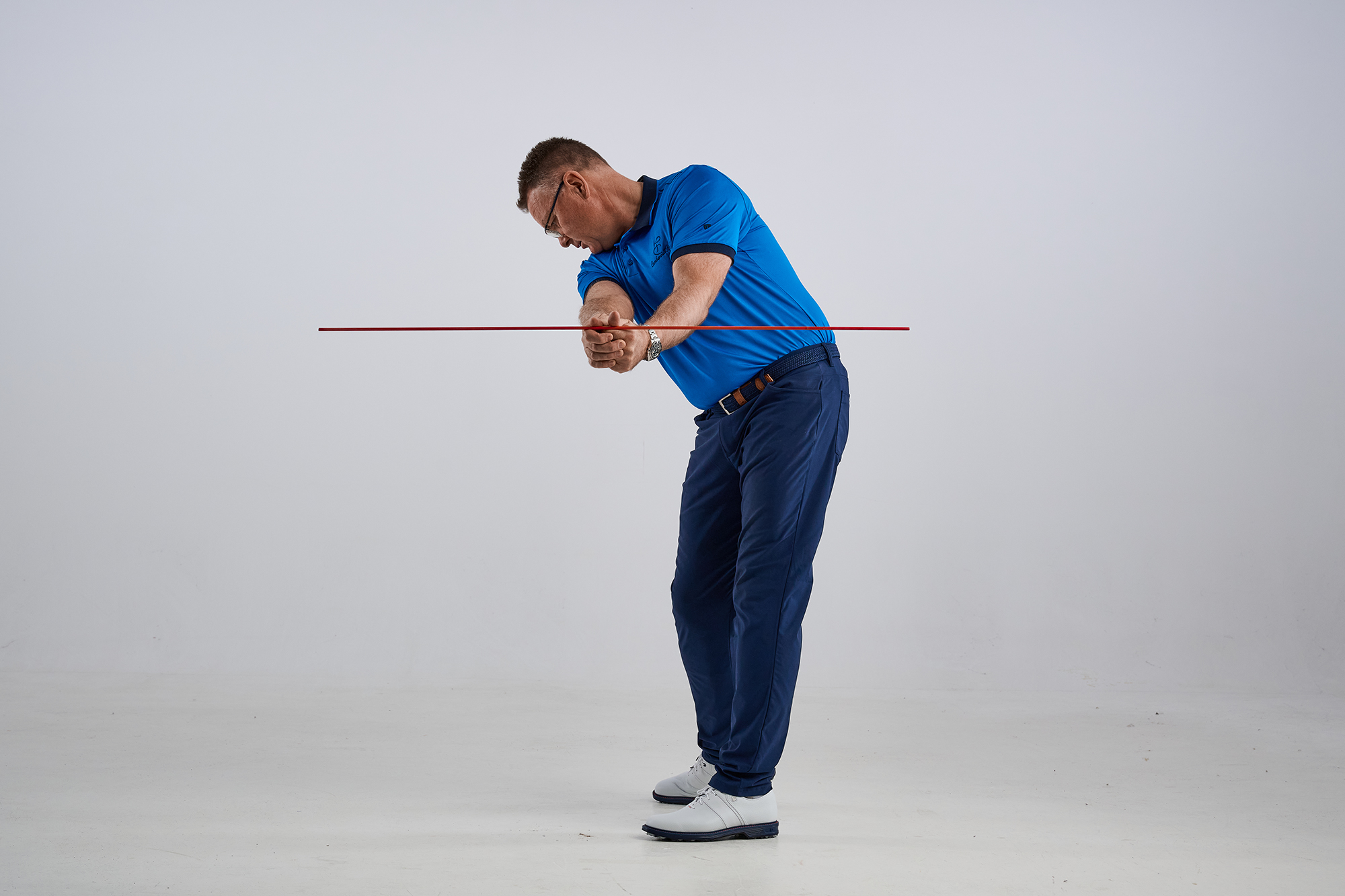 John Jacobs using an alignment stick to show the correct structure of the arms through impact