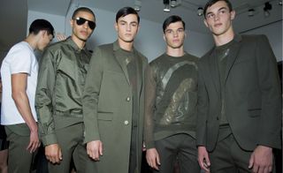 Models wearing Calvin Klein clothing in olive green colors